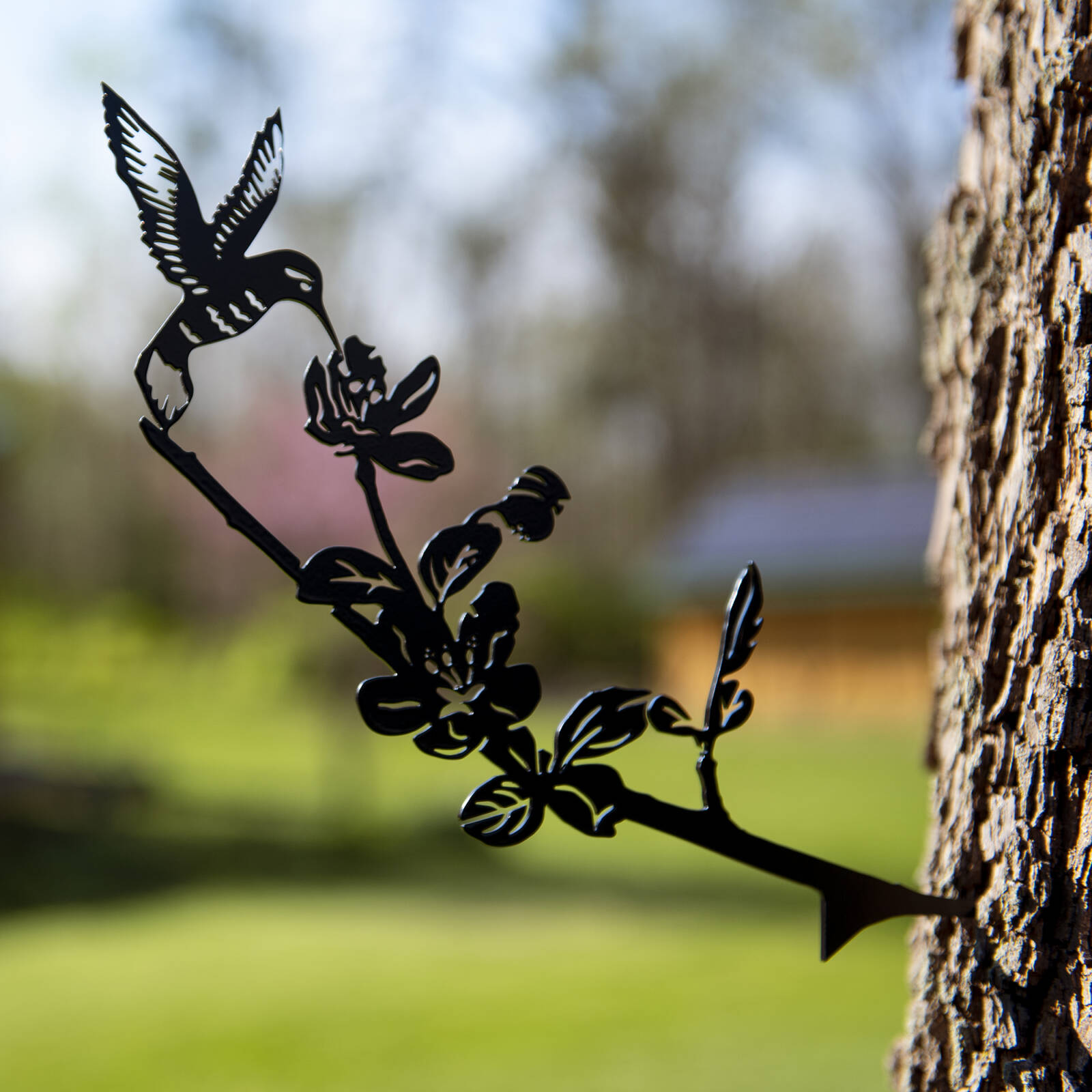 Decorative metal hummingbird attached to tree product photo by Robintek Photography