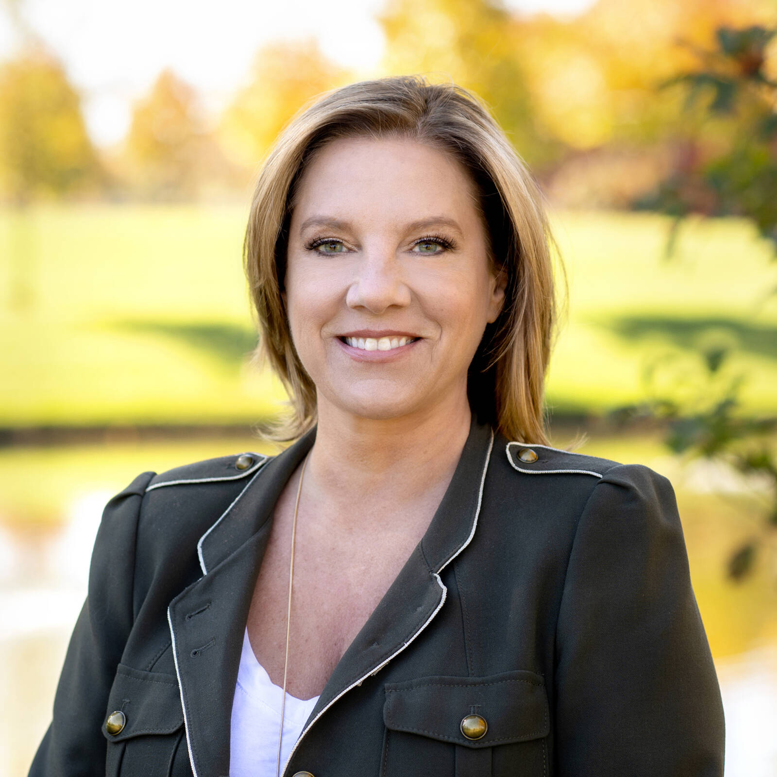 smiling business woman with fall park background