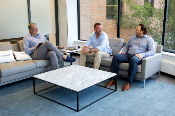 three business leaders talking in lounge area