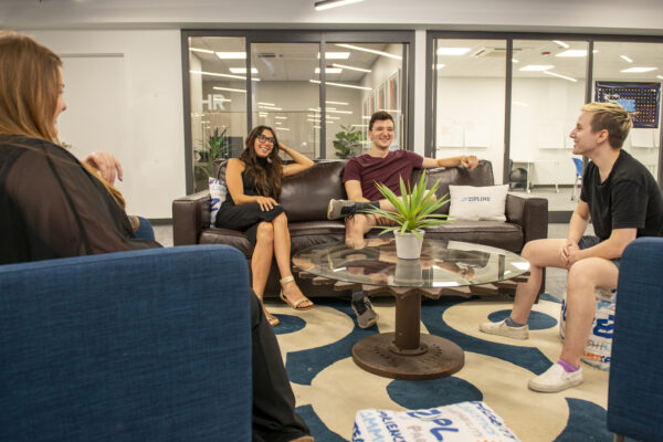 coworkers chat in lounge area